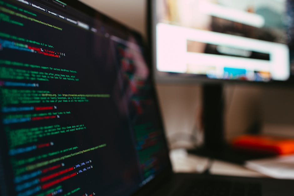 A detailed view of programming code displayed on a laptop screen, depicting a tech workspace